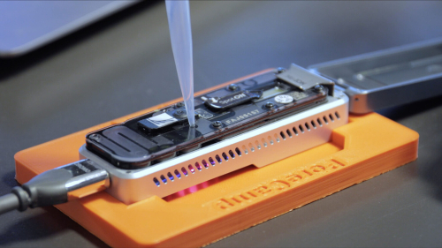 A pipette deposits copepod DNA into a DNA sequencer.
